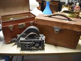 two suitcases and a camera sitting on a table