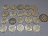 several different coins are arranged in a triangle on a table