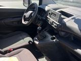 the interior of a small car with a steering wheel and dashboard