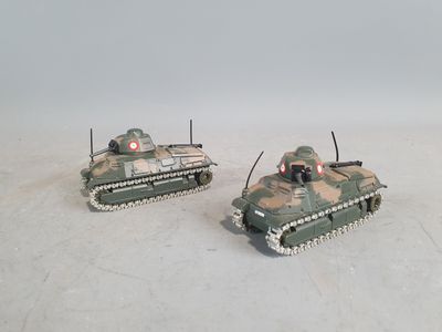 two toy tanks sitting side by side on a white surface