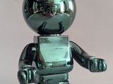 a shiny green toy that looks like a robot