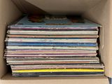 an open cardboard box filled with lots of different colored cds