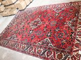 an image of a large red rug on the floor in a room