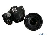 a camera and a lens sitting next to each other