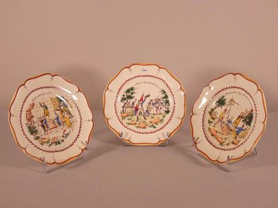 three plates with different designs on them sitting on a table