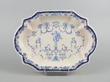 a blue and white plate with a design of birds and flowers