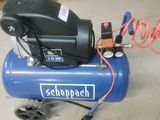 a blue air compressor sitting on the floor in a garage