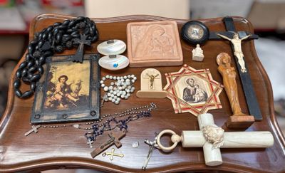 a table with a cross, rosary, and other religious items on it