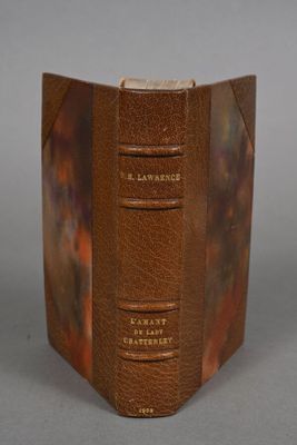 an old book with a brown cover sitting on top of a table