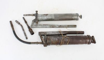 two old tools that are laying on a white surface