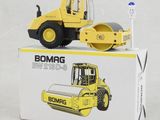 a small yellow construction vehicle sitting on top of a box