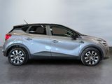 the silver car is parked in a large room with a white wall