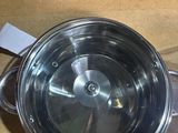 a metal pan with a lid on a counter top