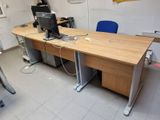 a computer desk with a monitor and a keyboard on it