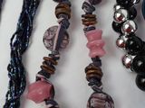 a lot of necklaces and bracelets on a table