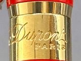 a close up of a red umbrella with a gold band