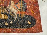 a tapestry with a picture of a man riding a horse on it