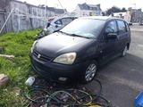 a black car that is parked in the grass