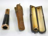 three different types of brass and leather items on a white surface