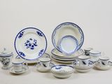 a lot of blue and white dishes and cups
