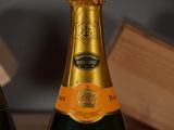a bottle of champagne sitting next to a bottle of wine