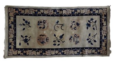an old rug with blue and white flowers on it