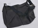a black leather purse with a black strap on a white background