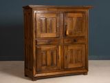 an old wooden cabinet with two doors and two drawers