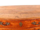 a small wooden chest of drawers sitting on a table