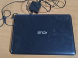 a laptop computer sitting on a table with a charger