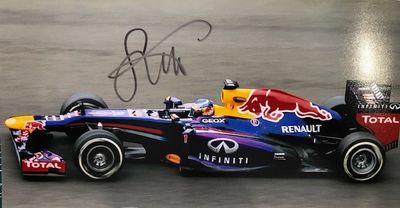 signed photo of a red bull racing car on a race track