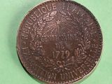 a close up of a coin on a green surface