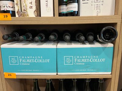 des bouteilles de vin sur une étagère dans un magasin, destinées à la vente
