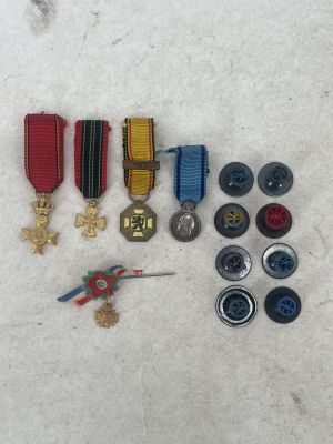 a lot of medals and buttons on the ground