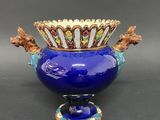 a blue vase with a horse head decoration on it