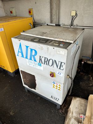 two air dryers sitting next to each other in a garage