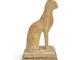 an egyptian statue of a cat sitting on top of a stone block