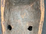 a wooden object with holes in it on a table