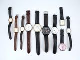 several different types of watches are lined up on a white surface
