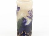 a tall vase with purple flowers painted on it