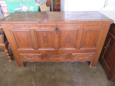 a wooden chest sitting in the middle of a room