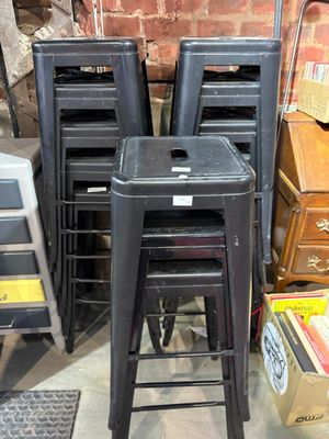 a lot of stools that are stacked on top of each other