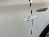 a sticker on the side of a white car