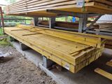 a large pile of lumber sitting on the ground
