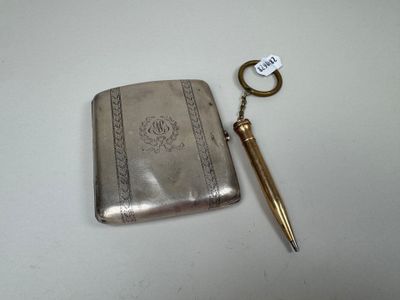 a silver case with a pen and a key in it