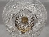 a glass bowl with a gold coin inside of it
