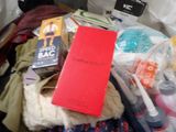 a red book sitting on top of a pile of clothes