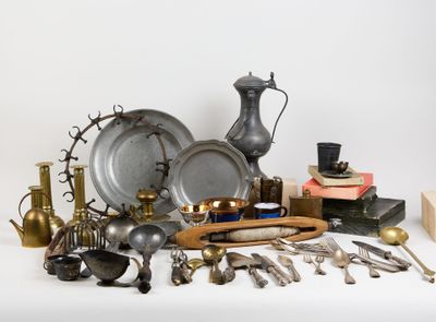 a lot of silver and brass items on a table