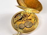 a gold pocket watch with a chain hanging from it