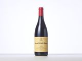 a bottle of red wine sitting on top of a table